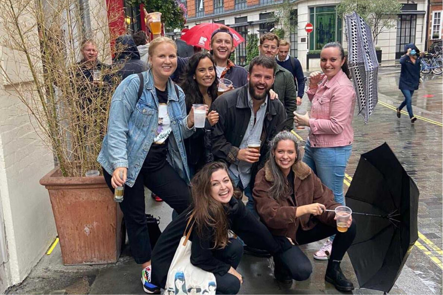 group of people posing to the picture on the street while raining